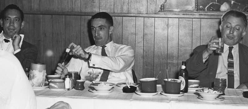 JPL engineer Albert R. Hibbs flipping butter at a banquet table