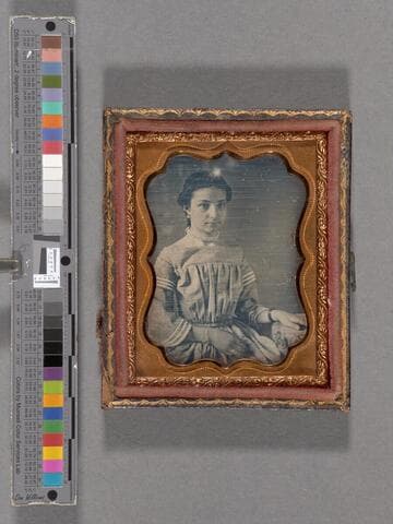 Portrait of unidentified adolescent girl wearing beaded necklace