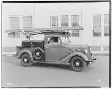 Edison Troubleman's Ford truck in front of Studebaker buildings