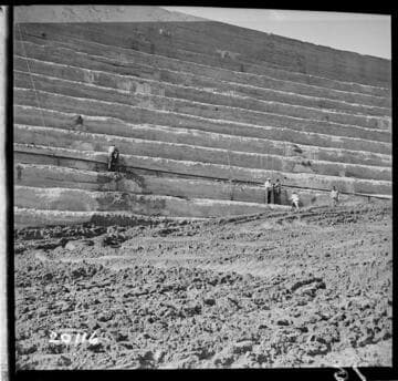 4" iron pipe drain connecting two tile weepers to West and above tile weeper near East end of 11th step