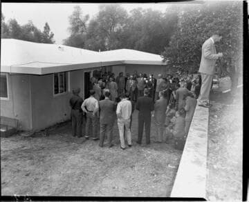 Ceremony in back yard of Millionth Meter home with family, large crowd of guests,  photographers, and cinematographers