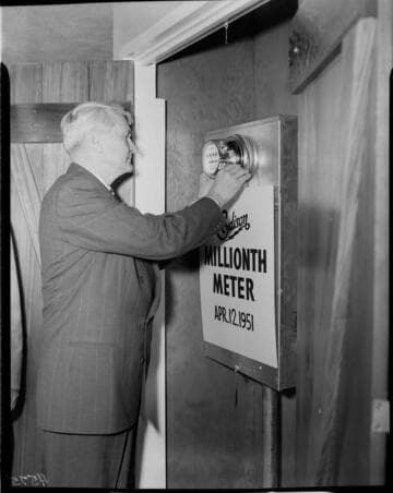 Edison's One Millionth Meter being set in panel by man in suit