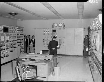 Group peeking into control room at Etiwanda power plant