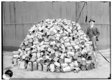 Edison Scrap Drives - A man standing beside a pile of junk coffee pots.  The image is almost identical to that of 02