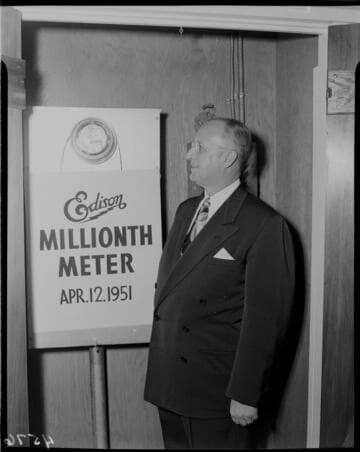 Edison executive standing by installed One Millionth Meter