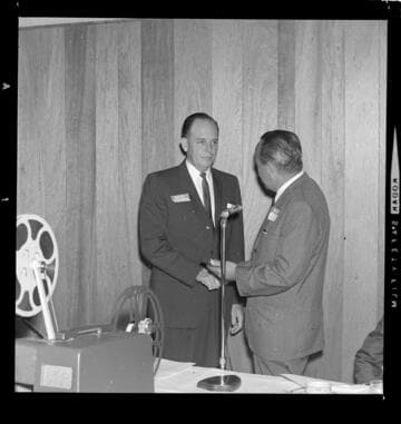 Award being presented to unknown recipient at a meeting