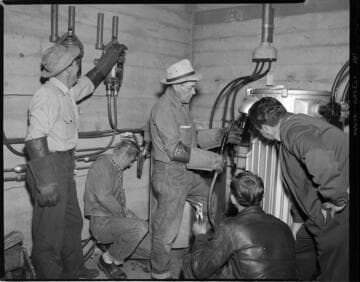 Electrical workers at work in underground vaults and on poles