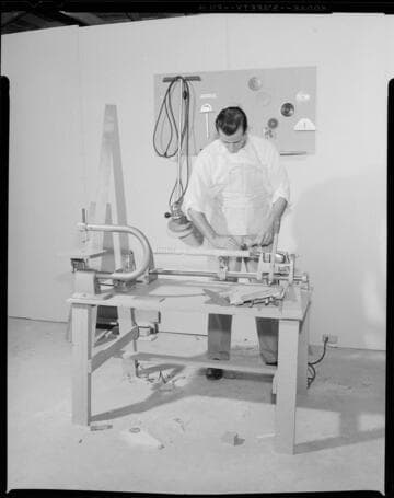 Man using Cummins woodworking tools in his garage