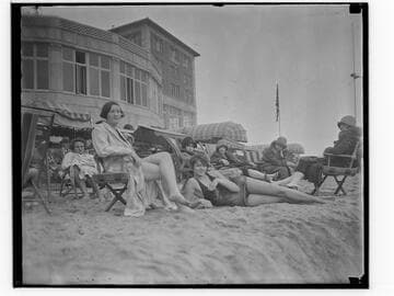 Swim team in beach chairs in front of the Club Casa del Mar, Santa Monica, California
