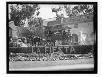 Performers in a horse drawn wagon on stage at Santa Monica High School Fiesta