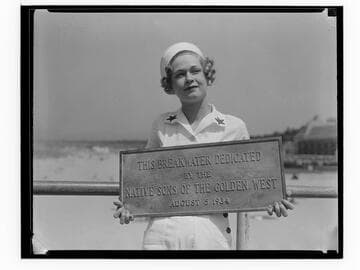 Woman holding dedication plaque for the Yacht Harbor Breakwater dedication, Santa Monica