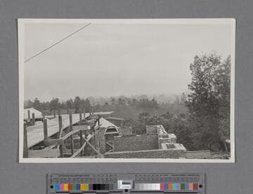 Huntington Library Construction: view showing the construction of walls of the the East Wing and the Main Building; taken from scaffold looking east