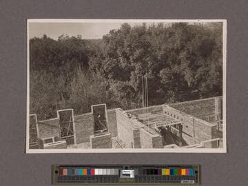 Huntington Library Construction: view showing the brick walls of the Main Building and the West Wing, taken from scaffold