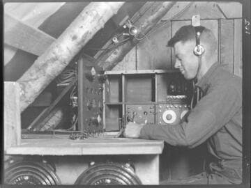 Operator in radio shack receiving and recording a message