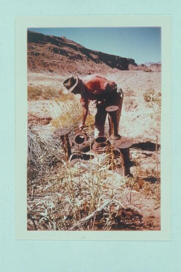 Dock Marston examines old sluicing head stand, Cass Hite's "Bank of Tickaboo."
