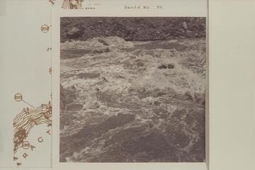 Across from left bank below head of Rapid 22 in The Big Drop.  The rock with the rounded top appears in 2711 CTCN 3 and in Bennett #8-90 of 1964, June.  In this Sleight photo the river stage is higher than in the 1927 and 1964 photos