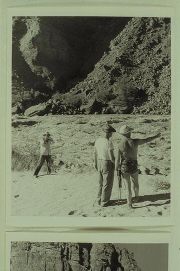 Marston outlines the selected course to Taylor while Ed Hudson gets a picture