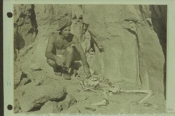 Nevills posing at skeleton with substitute skull