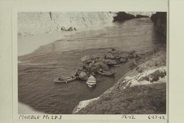 The Mortenson-Reilly-Litton boats landed at Mile 28.3.  The rocks are part of the fan appearing in the Hillers photo 445