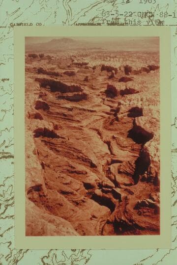 Northeasterly up Stevens Canyon.  Mt. Hillers in the distance with the low cliffs at the left bank of Hall Creek below.  The finger at upper right is shown on the map with an elevation of 5097