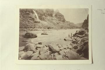 Photo from Edwards Collection captioned, "When we tried to get the wrecked boat."  Kane and McDonald are on the rock and the boat is pinned against it.  The accident occurred in 1891 on the Best Expedition