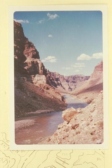Up Cataract Canyon from Mile 203.  The island at lower left is covered in high water.  Rapid No. 19 is in the middle distance.  Last week of June, 1960