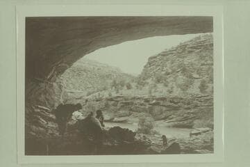 Margaret Marston and Becky Walker dig in the ruins of the Basket Makers Cave on the Dolores River while Pres Walker drags on a cigarette.  Ditty at the right