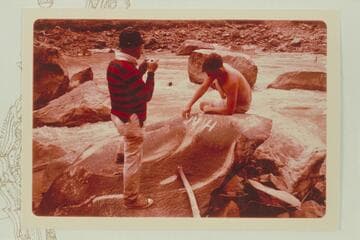 Buzz Belknap points up the H Mc inscription for Dock Marston's photography.  JsBest's name is at right.  Mile 204 1/2 right bank