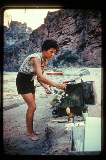 Margie cooks; camp, Mile 164