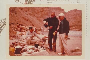 Dock Marston watches for the last drop as Bill Belknap pours the breakfast coffee.  Camp at Mile 209.6 RB.  Buzz Belknap watches.  The lower end of Rapid #6 in the background