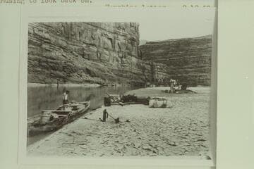 Camp on the Colorado River between Moab and the mouth of the Green River.  Two motor boats running tandem and the 10-ft. Fold-Flat boat of Nevills borrowing on the shore