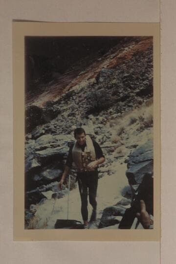 Bill Beer preparing for "swim" through Hance Rapid.  Hance was the only rapid which Beer and Daggett did not swim in 1955