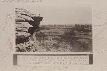 Up at head of Cataract Canyon from Mile 215 1/2.  View up Colorado from point on the rim 1200' above the river, one mile below mouth of Green River.  Sidney Paige on rock
