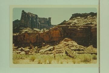 One of the Julien boys pointing to the D. Julien inscription in Hell Roaring Canyon