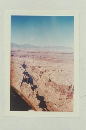 Down river from the end of Mille Crag Bend at Mile 174.5.  The mouth of the Dirty Devil and the Henry Mts. in distance