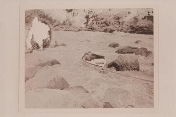 Nevills scrambles into the boat being lined at Lava Falls.  Garth Marston is handling the stern line at the left