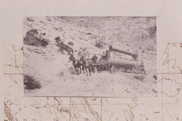 Boiler on the north side of Lees Ferry.  Teams on hillside above the road were hooked to rear of boiler as real wheels were tracking off the road.  Copy of print in Waller collection