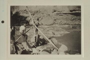Emery Kolb "cooning" out to the trapped boat at Dark Canyon.  USGS party under Chenoweth.  Tasker is at left and Lint is center.  Photo from Lint album