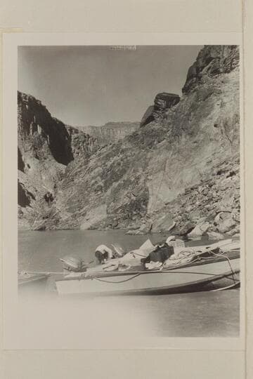 The two outboard boats, "Twin" and "June Bug" moored at camp at Mile 115 just above Elves Chasm.  The fault at this point brings up the Archean in the background