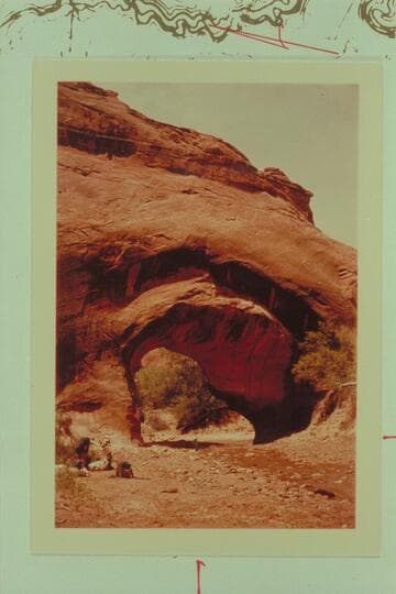 Bernice under center of Coyote Arch in Coyote Gulch