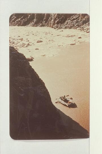 Sockdologer Rapids, Colorado River.  Inspecting rapids in small black boat