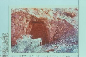 A bunk and mattress under an overhang at the camp at the Hance Asbestos Mine