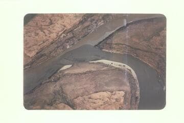 Junction of San Juan and Colorado.  Indian trail along left talus.  Faint trail on fluvial bench at left center.  8600 cfs. recorded at Lees Ferry