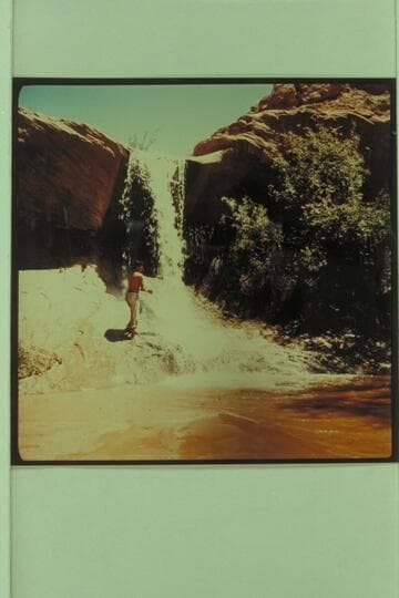 Waterfall in Lake Canyon 5.5 miles from the river.  Henry Silversmith, a Navajo from Chinle.  Arizona appears at the fall