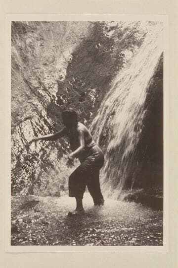 Lois Sanderson climbs out of the shower at the head of the travertine block in Travertine Canyon