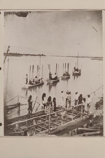 The start from Camp Mojave, Arizona.  Boat expedition under Lieut. Wheeler, the first and only one to ascend the Colorado River through the Grand Canyon to the mouth of Diamond Creek.  Note ferry in foreground which appears to have a rig for a sail