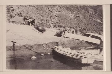The "Coronado" and the "Powell" on beach at Lees Ferry for repairs during stopover of the Eddy party from July 12 to 18.  The skiffs were in use in conjunction with operation of the ferry and the gauging station. The tents are those carried by Eddy