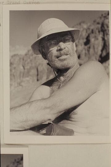 Otis "Dock" Marston answers some questions while piloting the motorboat in lower Grand Canyon