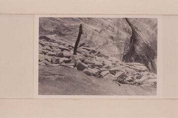 Looking up to face of ruin and stick.  Inside of downriver wall forming stub canyon at foot of Valentine Bottom at Mile 24.6