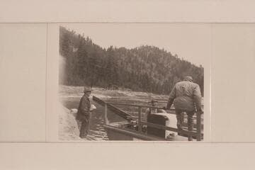 Don Smith in his 30-ft. sweep scow on the Salmon River.  Near Shoup.  Note the refrigerator